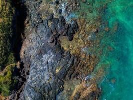 Aerial View of Rugged Coastline with Volcanic Rocks in Oahu, Hawaii photo