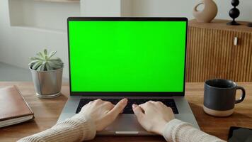 Female hands typing on laptop keyboard with green screen, unrecognizable identity, no face, close-up, copy space, chroma key, mockup, 4k , red komodo. video