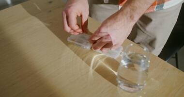 A man takes out pills from an organizer and drinks them with water, a close-up of male hands, the man's face is not visible video