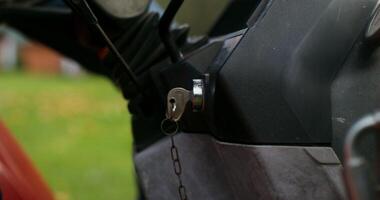 A man gets into an agricultural tractor and turns the key in the ignition, close-up of the key, the man's face is not visible video