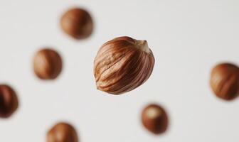 A nut is shown in the air with other nuts below it photo