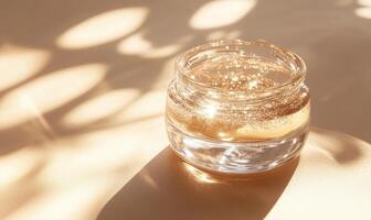 A small jar of liquid is sitting on a table photo