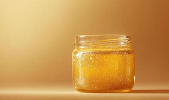 A jar of honey is sitting on a table photo