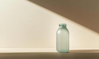 A clear bottle with a green cap sits on a white surface photo