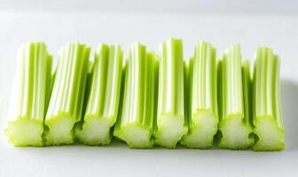 A bunch of celery sticks are cut in half photo