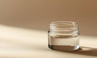 A clear jar with a lid is sitting on a table photo