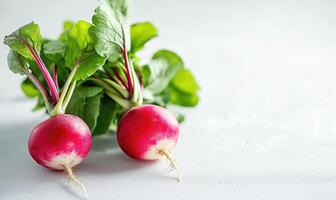 Two radishes are on a white table photo