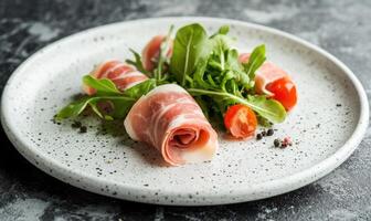 A plate of ham and greens with a tomato on top photo