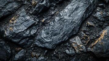 A close up of a rock with a dark grey color and some gold specks photo