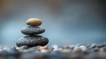 Zen stones stacked in balance against a blurred background, symbolizing harmony and tranquility in nature. Stone pyramid on pebble beach. photo