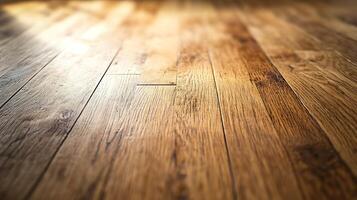 Close-up view of wooden flooring with a golden-brown hue, showcasing natural wood grain patterns and textures with soft light reflecting across the surface. photo
