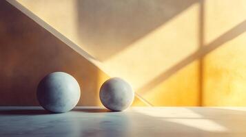 Two spheres rest on a marble surface, bathed in warm sunlight against a painted wall. Shadows create an interesting contrast. photo