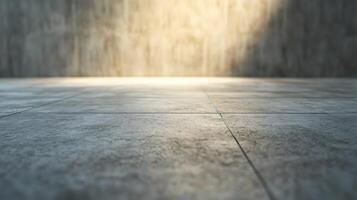 Monochromatic scene with gray tiled floor and wall. Light creates soft textures and forms in the concrete-like setting. photo