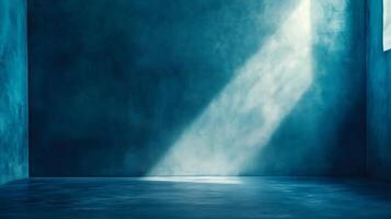 A ray of light shines into a blue, empty room, highlighting the texture of the walls and floor with a sense of ethereal tranquility. photo