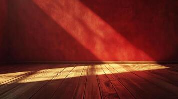 Sunlight streams through the window onto a rich red wall and hardwood floor, creating a warm and inviting atmosphere in the room. photo