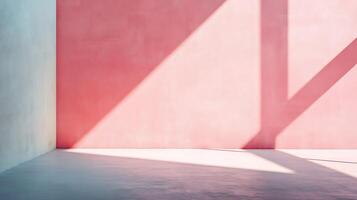 Abstract room with a pink wall and sunlight casting shadows. The floor has a subtle gradient, and the adjacent wall is light blue. photo