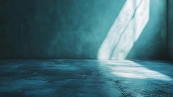 Light streams through the concrete room, casting a bright, diagonal glow on the wall and floor, creating shadows and an airy atmosphere. photo