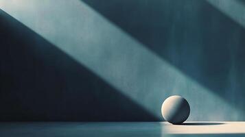 A sphere sits bathed in light against a textured wall, stark shadows cut through the scene, creating a minimalist, architectural feel. photo