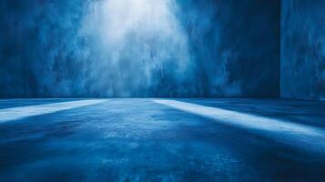 A textured blue space illuminated with a dramatic spotlight shining on the concrete floor and walls, creating a mysterious atmosphere. photo