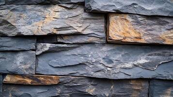 Detail of stacked, chiseled stone, creating a layered texture with a mix of gray and light brown rock fragments in an abstract pattern. photo