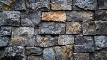 Solid brick wall surface, textured rock structure of stone masonry, weathered facade of a house, gray stone, textured background. photo