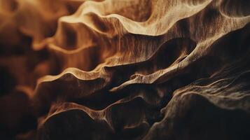 Abstract waves of golden-brown textures create a unique, organic pattern resembling sand dunes or wood grain, adding depth and visual interest. photo