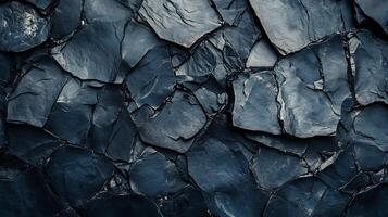 Close-up shot of jagged, dark-colored rock formations in a natural setting, showcasing textures and geological patterns. photo