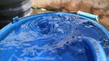 A bucket with water in it and a blue handle video