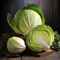 A close-up photograph of three cabbages on a wooden table photo