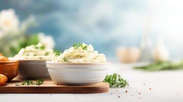 Mashed potatoes in bowls with herbs and vegetables photo