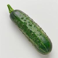 A cucumber with a green skin and a small leafy top photo