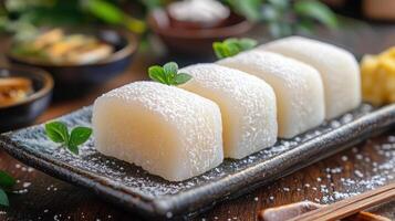 Japanese daifuku mochi with red bean paste filling on a plate photo