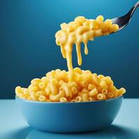 Bowl of macaroni and cheese with a spoonful photo