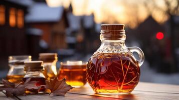 Glass bottles filled with maple syrup and autumn leaves. photo