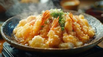 A bowl of shrimp tempura with sauce and green onions photo