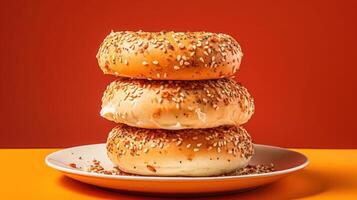 A stack of three bagels on a plate. photo