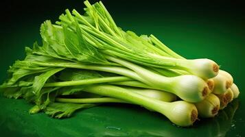A bunch of celery stalks on a green background photo