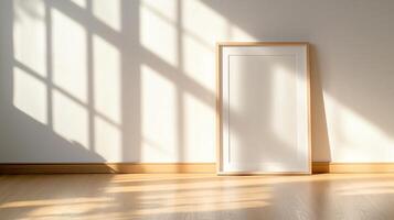 A blank picture frame leans against a light wall, illuminated by soft sunlight streaming through a window, creating a tranquil and inviting atmosphere in a cozy indoor space. photo