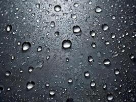 A high-definition macro image showing water droplets forming random, intricate designs. photo