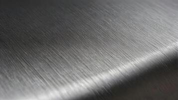A macro photograph of a modern stainless steel surface with linear grain patterns. photo