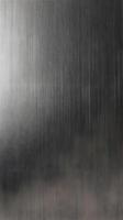 A sharp macro capture of brushed stainless steel with a sleek, metallic sheen. photo