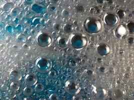 A high-resolution macro shot of plastic film with air pockets, forming a textured, bumpy surface. photo