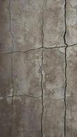 A high-resolution close-up of rough cement, displaying subtle cracks and an aged texture. photo