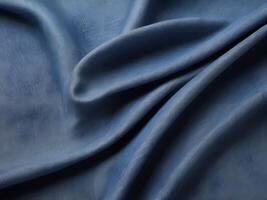 A sharp close-up of denim material, displaying its interwoven threads and rugged surface. photo