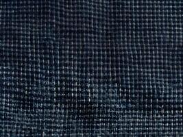 A high-resolution close-up of classic denim, highlighting its tight weave and rugged fibers. photo