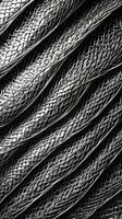 A detailed macro image of metal wire mesh, with repeating geometric forms woven together. photo