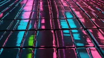 A close-up of neon light reflections illuminating the smooth, brushed metal texture. photo