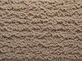 A sharply focused macro capturing the intricate fibers of a frayed carpet. photo