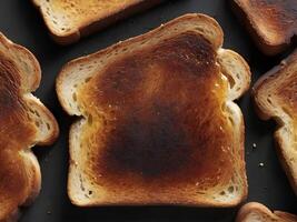 A close-up of a slice of toast, crisp and brown with a slight charred texture. photo