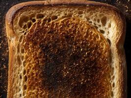 A close-up shot of toasted bread with a crisp, rich brown crust and a hint of burn. photo